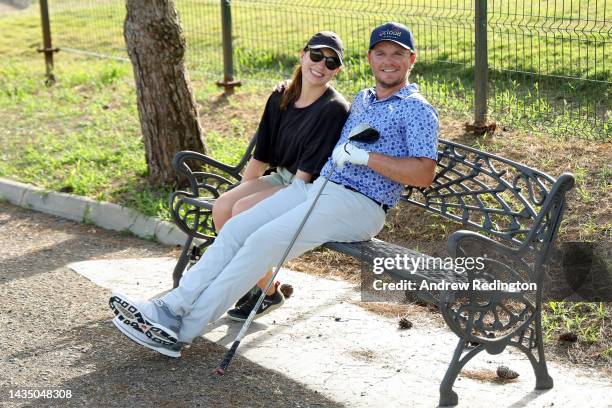 Eddie Pepperell of England sits on a bench with their girlfriend Jennifer Rhodes on the 3rd hole on Day One of the Mallorca Golf Open at Son Muntaner...
