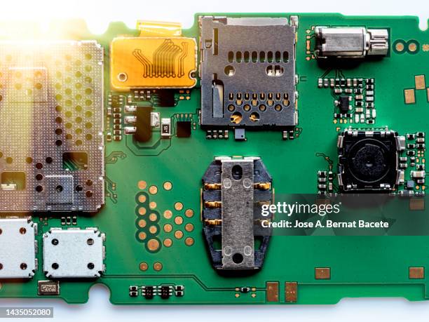 printed circuit board of a mobile phone with the slot to insert the sim card - computer repair background stock pictures, royalty-free photos & images