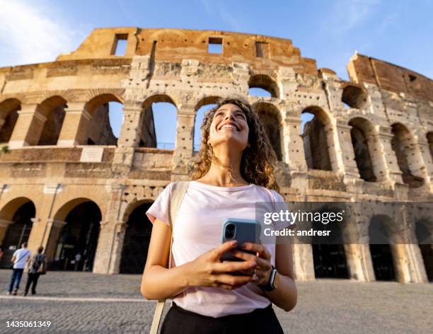 happy tourist in rome visiting the coliseum - rome tourist stock pictures, royalty-free photos & images