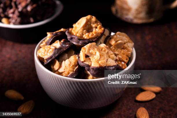 chocolate florentines cookies with almond in a ceramic bowl - stock photo - almond caramel stock pictures, royalty-free photos & images