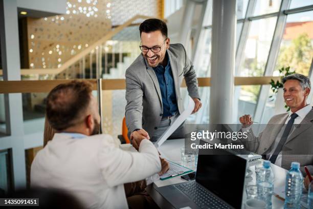 handshake between two business people for reaching a new agreement - initiative stock pictures, royalty-free photos & images