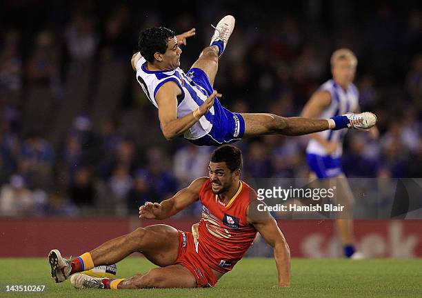 Lindsay Thomas of the Kangaroos collides with Karmichael Hunt of the Suns in a marking contest during the round five AFL match between the North...