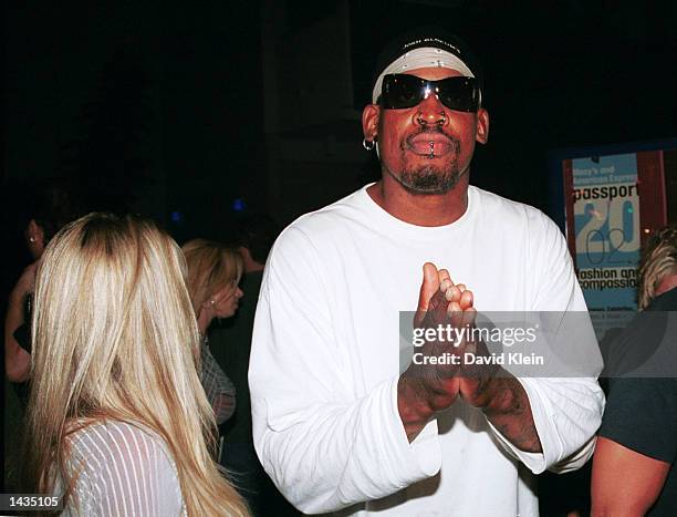 Celebrity Dennis Rodman exits the Standard Hotel with an unidentified woman on September 19, 2002 in West Hollywood, California.