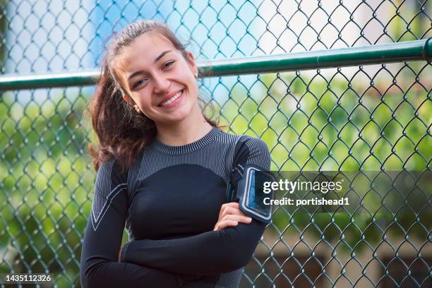 portrait of a smiling teenage girl doing sports in the city - daily sport girls bildbanksfoton och bilder