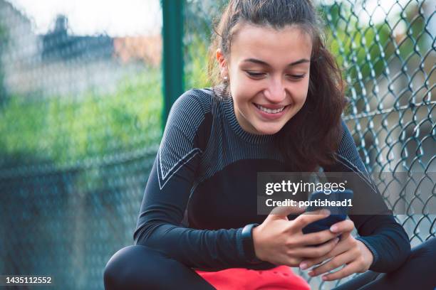 portrait of a smiling teenage girl resting after doing sports - daily sport girls bildbanksfoton och bilder