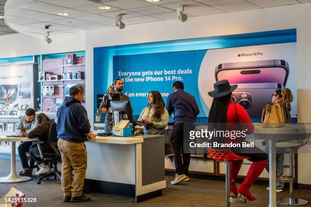 Employees assist customers in an AT&T store on October 20, 2022 in Houston, Texas. AT&T stock has climbed over 9 percent after having a successful...