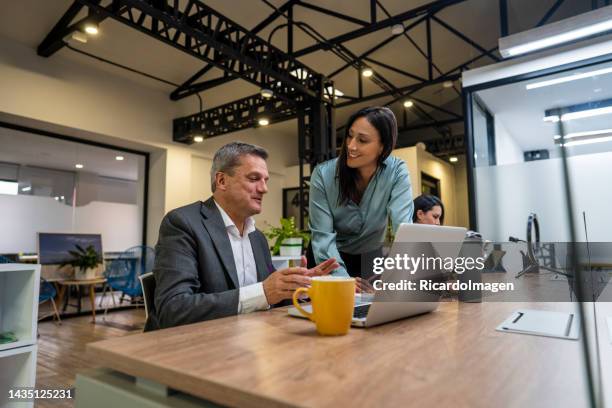 co-workers seek solutions for their company's finances - latin script stock pictures, royalty-free photos & images