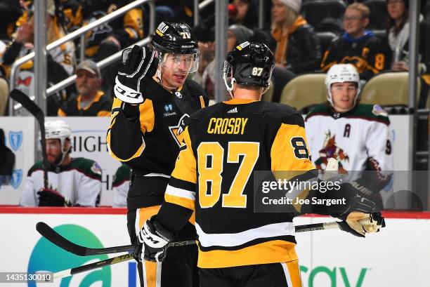 Evgeni Malkin talks with Sidney Crosby of the Pittsburgh Penguins during the game against the Arizona Coyotes at PPG PAINTS Arena on October 13, 2022...