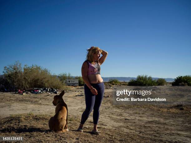 Ashley Hanson stays in a remote stretch of southern California desert where at least 200 unhoused people live outside, battling the extremes: blazing...