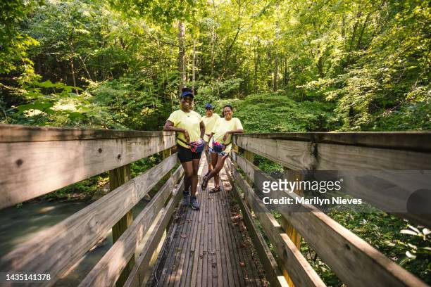 group of friends on a bridge enjoying nature - "marilyn nieves" stock pictures, royalty-free photos & images