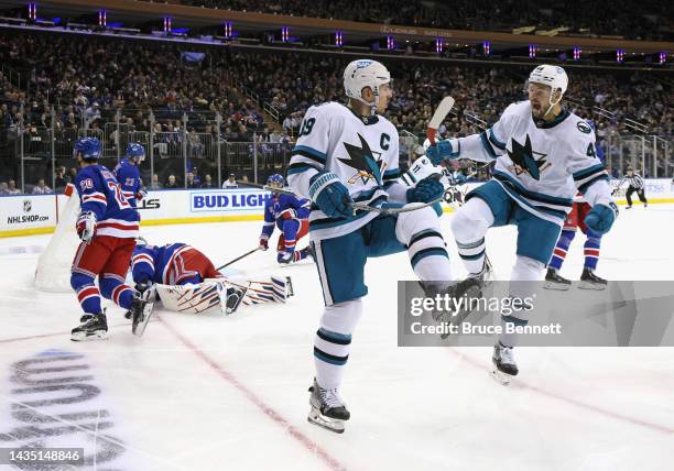 Logan Couture of the San Jose Sharks celebrates his first period goal against Igor Shesterkin of the New York Rangers along with Tomas Hertl at...