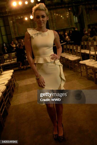 Miley Cyrus attends Marchesa's fall 2013 runway show in Celeste Bartos Forum at the New York Public Library.