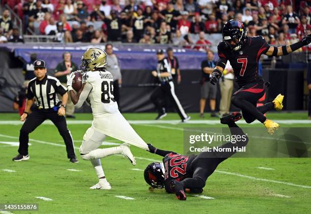 Rashid Shaheed of the New Orleans Saints makes a catch for a touchdown as Marco Wilson and Byron Murphy Jr. #7 of the Arizona Cardinals defend during...