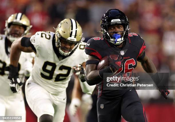 Eno Benjamin of the Arizona Cardinals carries the ball as Marcus Davenport of the New Orleans Saints chases during the 1st quarter of the game at...