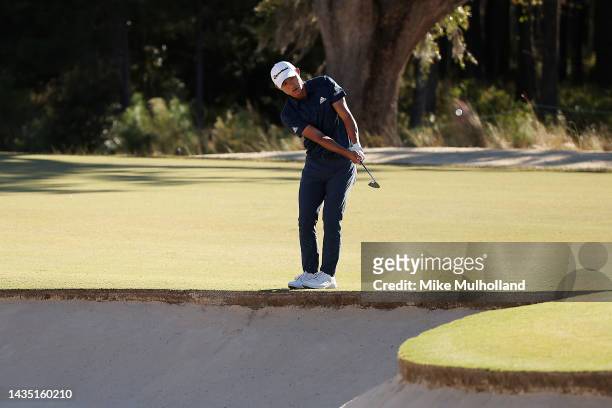 Collin Morikowa of the United States hits a chip shot from the edge of a bunker on the 13th hole during the first round of the CJ Cup at Congaree...