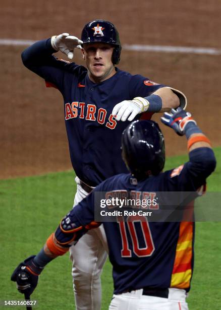 Alex Bregman of the Houston Astros celebrates his three-run home run against the New York Yankees with Yuli Gurriel during the third inning in game...