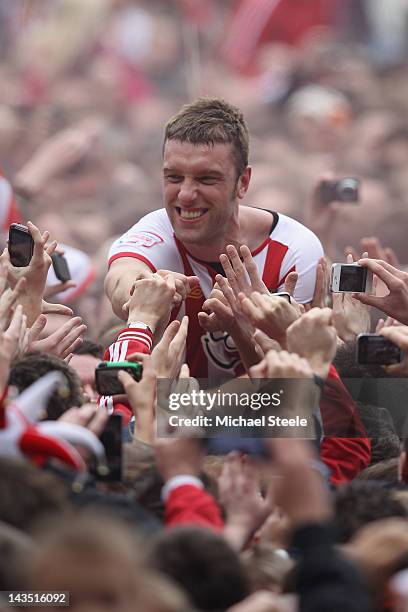Rickie Lambert of Southampton is carried on home supporters shoulders as he celebrates promotion after his sides 4-0 victory during the npower...