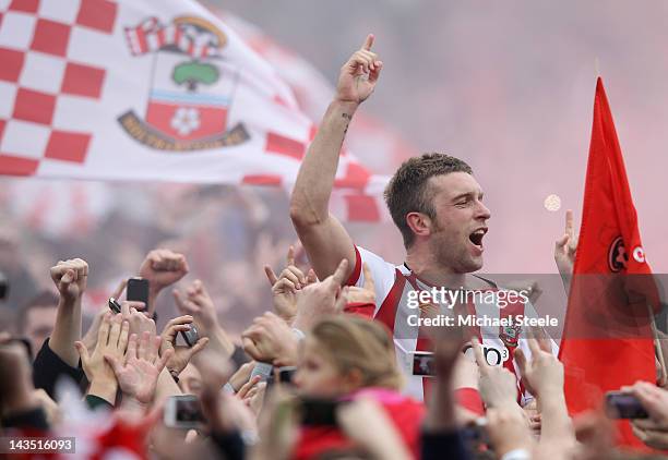 Rickie Lambert of Southampton is carried on home supporters shoulders as he celebrates promotion after his sides 4-0 victory during the npower...