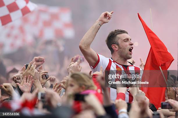 Rickie Lambert of Southampton is carried on home supporters shoulders as he celebrates promotion after his sides 4-0 victory during the npower...