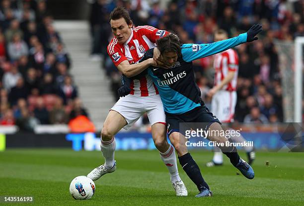 Dean Whitehead of Stoke City holds off Tomas Rosicky of Arsenal during the Barclays Premier League match between Stoke City and Arsenal at Britannia...