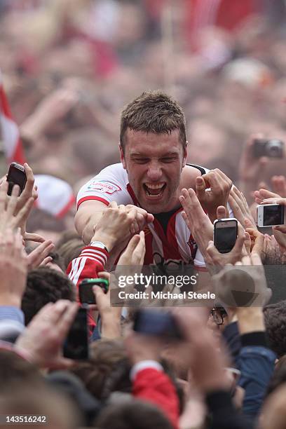 Rickie Lambert of Southampton is carried on home supporters shoulders as he celebrates promotion after his sides 4-0 victory during the npower...