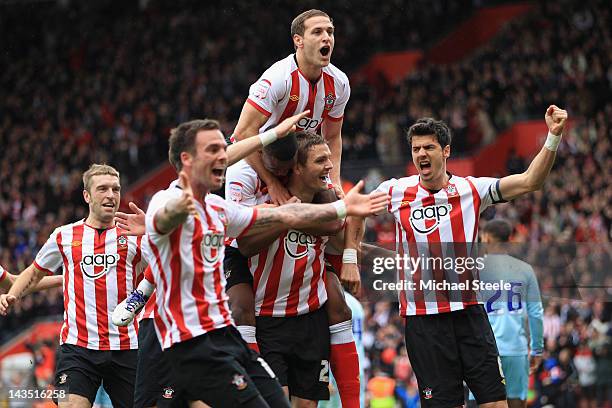 Billy Sharpe of Southampton jumps on the back of goalscorer Jos Hooiveld after the third goal during the npower Championship match between...