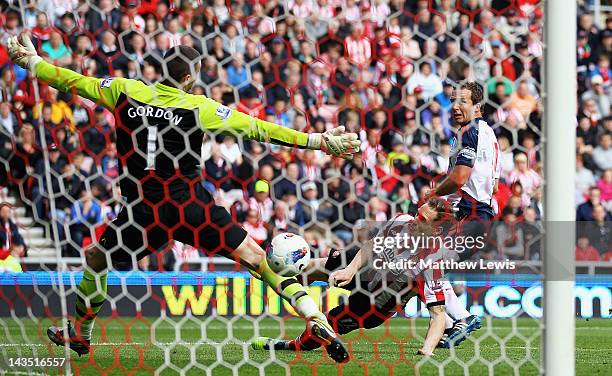 Kevin Davies of Bolton beats the tackle of Matthew Kilgallon of Sunderland to score a goal during the Barclays Premier League match between...