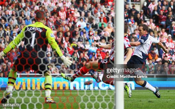 Kevin Davies of Bolton beats the tackle of Matthew Kilgallon of Sunderland to score a goal during the Barclays Premier League match between...