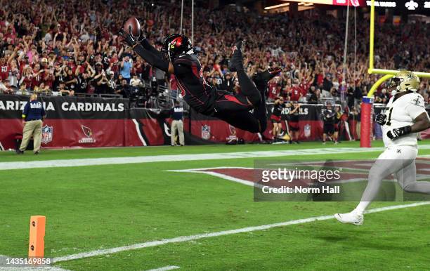 Marco Wilson of the Arizona Cardinals dives into the end zone for a touchdown after intercepting a pass during the game against the New Orleans...