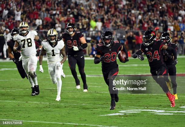 Marco Wilson of the Arizona Cardinals carries the ball on his way to a touchdown after intercepting a pass during the 2nd quarter of the game against...