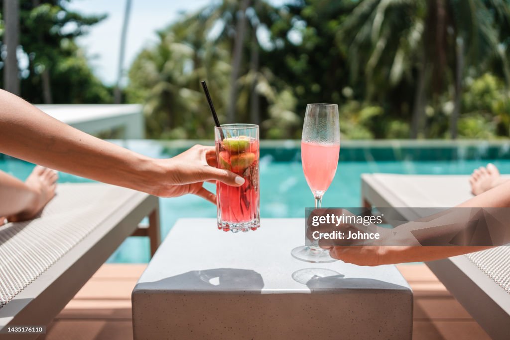 Friends clinking glasses with cocktails