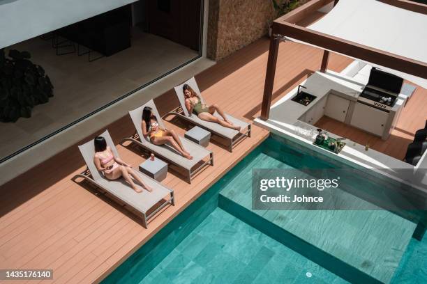 friends  enjoying vacation by the pool - thailand hotel stock pictures, royalty-free photos & images