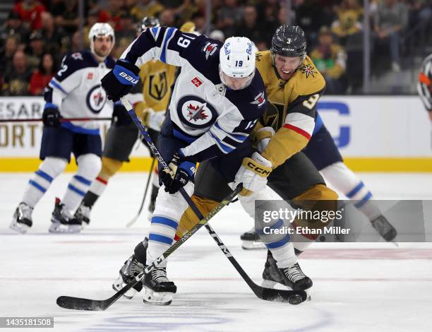 David Gustafsson of the Winnipeg Jets and Brayden McNabb of the Vegas Golden Knights \vie for the puck in the first period of their game at T-Mobile...