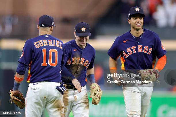 Yuli Gurriel, Alex Bregman, and Jeremy Pena of the Houston Astros celebrate after their team's 3-2 victory against the New York Yankees in game two...