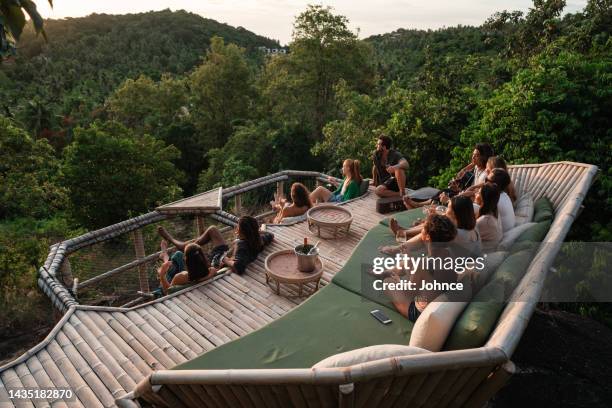 friends enjoy watching the sunset - hammock asia stock pictures, royalty-free photos & images