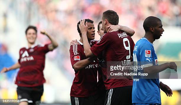 Tomas Pekhart of Nuernberg celebrates after scoring his team's third goal while Ryan Babel of Hoffenheim looks dejected during the Bundesliga match...