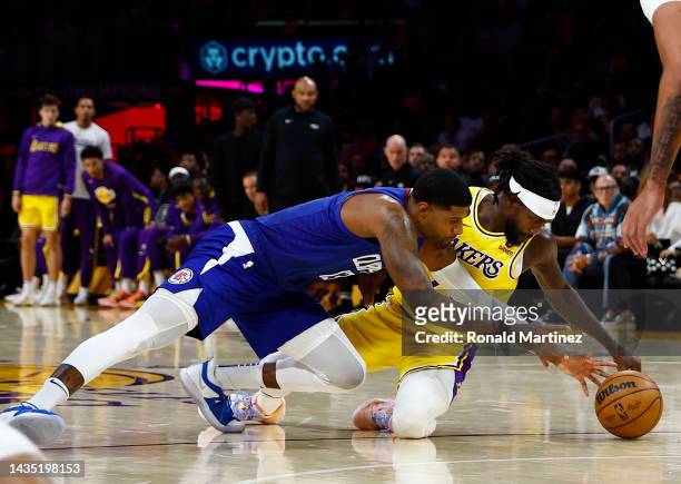 Paul George of the LA Clippers and Patrick Beverley of the Los Angeles Lakers dive for the ballin the third quarter at Crypto.com Arena on October...