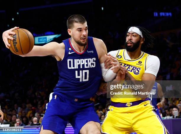 Ivica Zubac of the LA Clippers controls the ball against Anthony Davis of the Los Angeles Lakers in the third quarter at Crypto.com Arena on October...