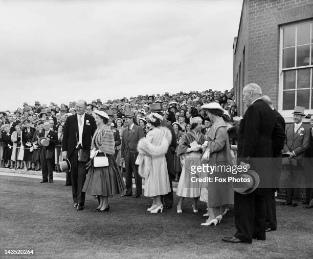Queen Elizabeth II and Princess Margaret with racehorse trainer Sir Cecil Boyd-Rochfort during the Royal Hunt Cup at Ascot, 20th June 1956. Also...