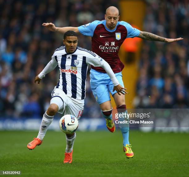 Jerome Thomas of West Bromwich Albion holds off a challenge from Alan Hutton of Aston Villa during the Barclays Premier League match between West...