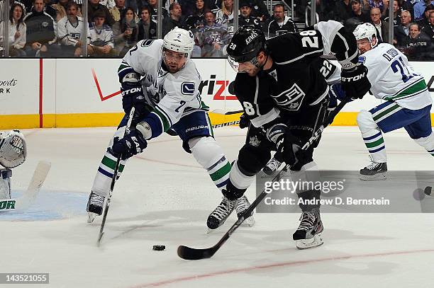 Jarret Stoll of the Los Angeles Kings skates with the puck against Dan Hamhuis of the Vancouver Canucks in Game Four of the Western Conference...