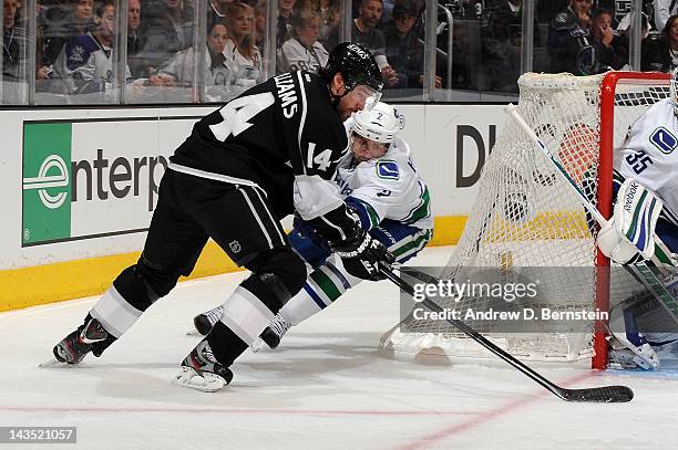 Justin Williams of the Los Angeles Kings skates with the puck against Dan Hamhuis of the Vancouver Canucks in Game Four of the Western Conference...