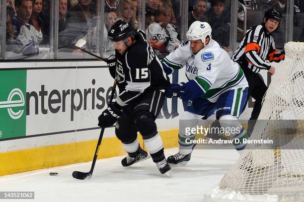 Brad Richardson of the Los Angeles Kings skates with the puck against Kevin Bieksa of the Vancouver Canucks in Game Four of the Western Conference...
