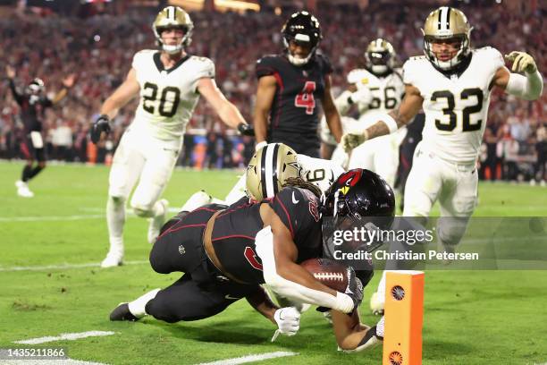 Running back Keaontay Ingram of the Arizona Cardinals dives for the corner of the end zone as Marcus Maye and Tyrann Mathieu of the New Orleans...