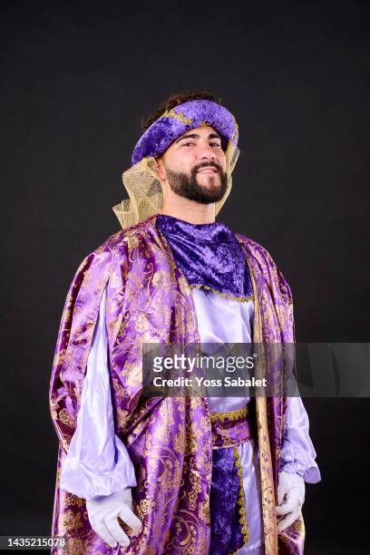 young dark-haired bearded man dressed as a moorish king looking at camera - king royal person stock-fotos und bilder