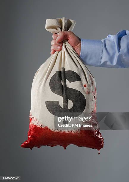 money bag dipped in blood - bribing stockfoto's en -beelden
