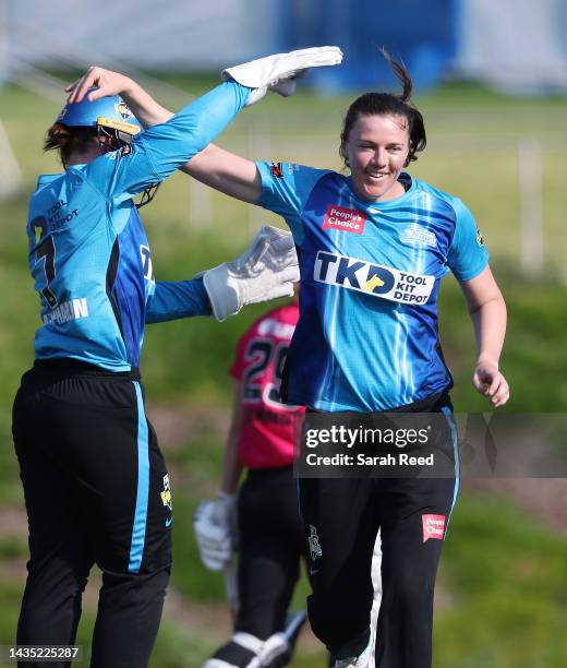 Tahlia McGrath of the Adelaide Strikers celebrates the wicket of Susie Bates of the Sydney Sixers out for 22 runs with Tegan McPharlin of the...