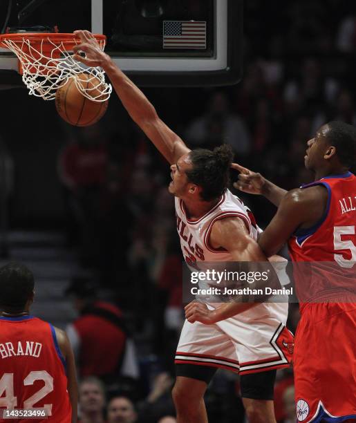 Joakim Noah of the Chicago Bulls dunks the ball over Elton Brand and Lavoy Allen of the Philadelphia 76ers in Game One of the Eastern Conference...