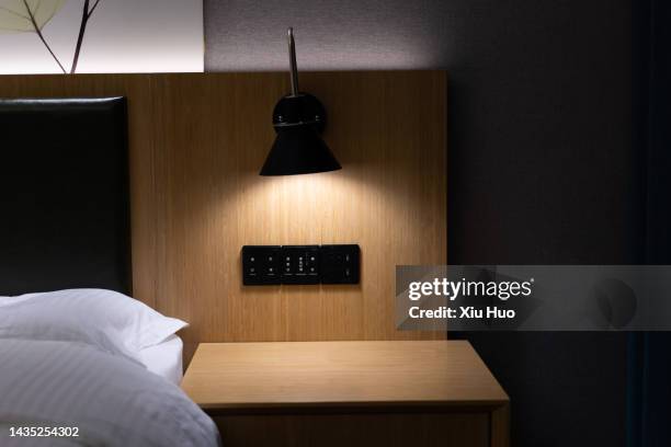 bedside lamp in bedroom - mesita de luz fotografías e imágenes de stock