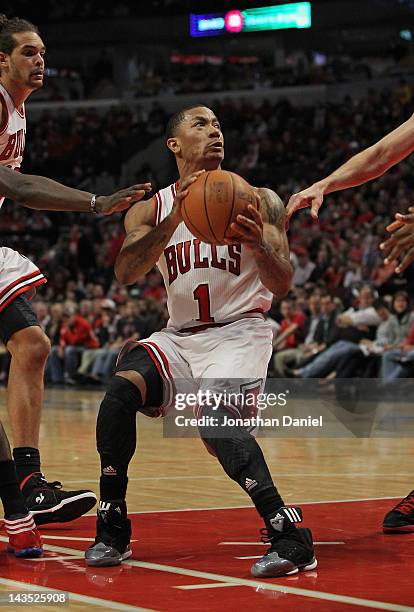 Derrick Rose of the Chicago Bulls drives against the Philadelphia 76ers and appears to injure his knee in Game One of the Eastern Conference...